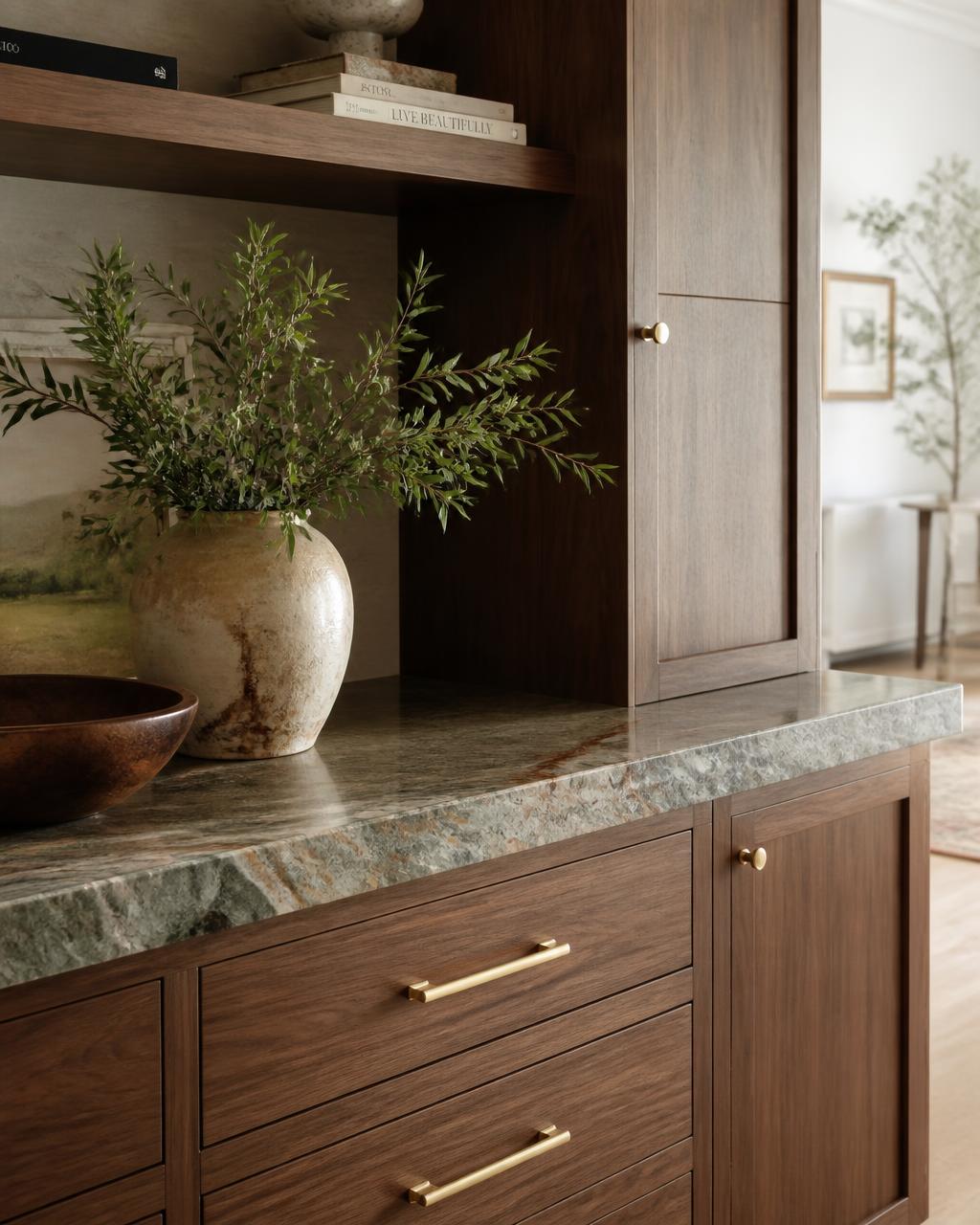 Detail of custom walnut millwork with quartzite counter and brass hardware